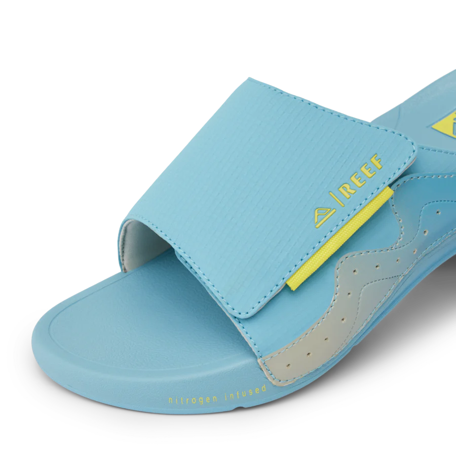 CJ7256_SWELL_CRUISER_SLIDE_LIGHT_BLUE_YELLOW_DTL1-900x900-c4cc11b.webp